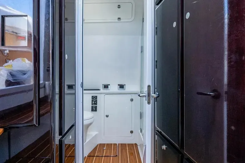  Yacht Photos Pics Interior of 2020 HCB 53 Sueños boat featuring a compact bathroom with wooden flooring.