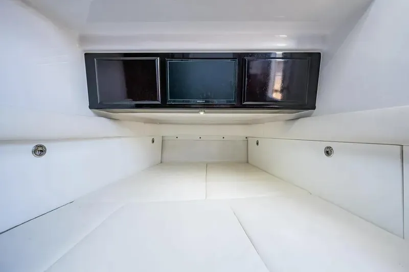  Yacht Photos Pics Interior cabin of 2020 HCB 53 Sueños boat, featuring sleek white design and storage compartments.