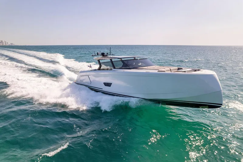 The Next Trade Yacht Photos Pics 2022 Vanquish Yachts VQ58 cruising on open sea, showcasing sleek design and performance.