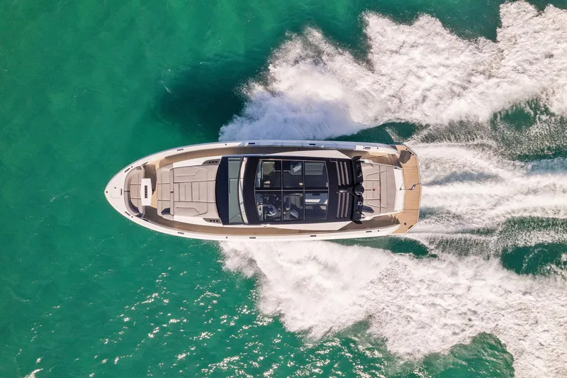 The Next Trade Yacht Photos Pics Aerial view of 2022 Vanquish Yachts VQ58 cruising on turquoise water.