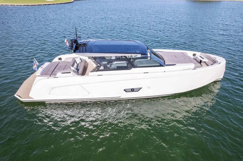 The Next Trade Yacht Photos Pics 2022 Vanquish Yachts VQ58 luxury yacht on calm water, side view.