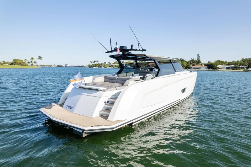 The Next Trade Yacht Photos Pics Vanquish Yachts VQ58 2022 model cruising on a serene lake.