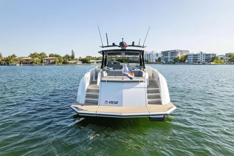 The Next Trade Yacht Photos Pics 2022 Vanquish Yachts VQ58 on water, rear view, modern design, sunny day.