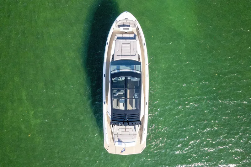 The Next Trade Yacht Photos Pics Aerial view of 2022 Vanquish Yachts VQ58 on green water.