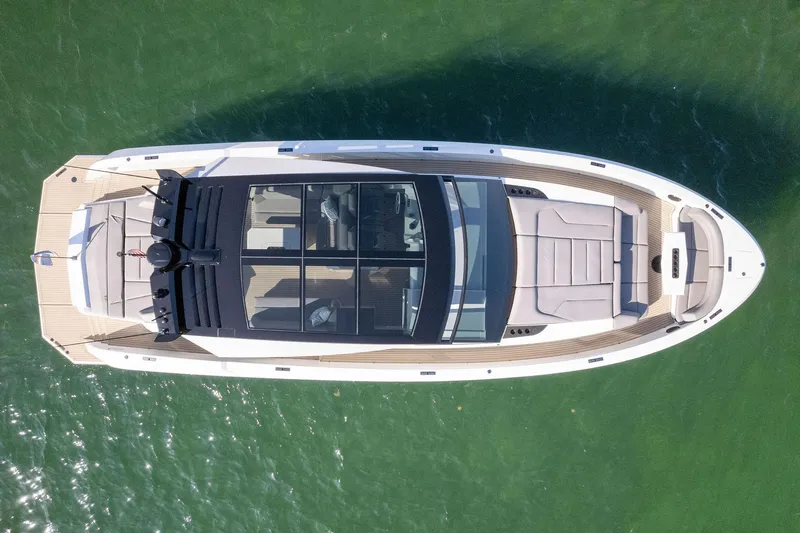 The Next Trade Yacht Photos Pics Aerial view of 2022 Vanquish Yachts VQ58 luxury yacht on green water.