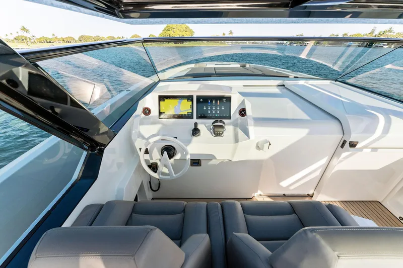 The Next Trade Yacht Photos Pics Modern helm of 2022 Vanquish Yachts VQ58 with sleek design and advanced navigation systems.