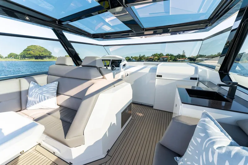 The Next Trade Yacht Photos Pics Luxurious interior of 2022 Vanquish Yachts VQ58 with sleek seating and panoramic views.