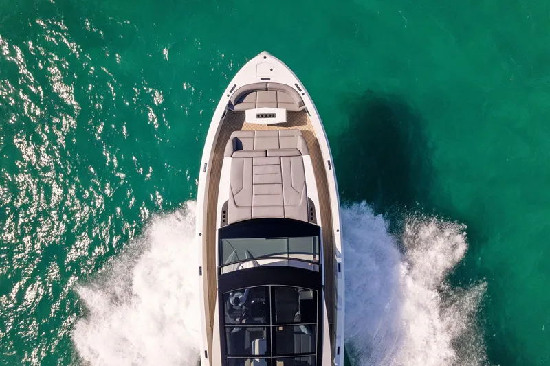 The Next Trade Yacht Photos Pics Vanquish Yachts VQ58 2022 cruising on turquoise water, aerial view.