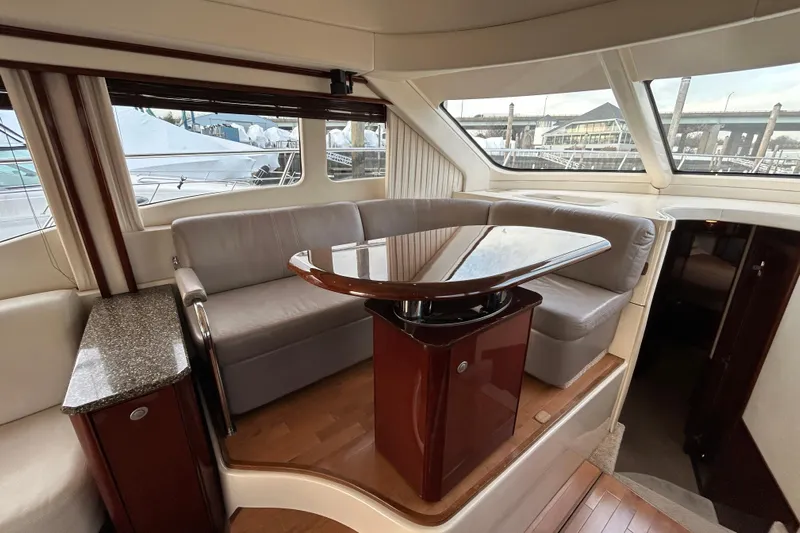  Yacht Photos Pics Luxurious interior of 2008 Sea Ray 52 Sedan Bridge yacht with elegant seating and table.