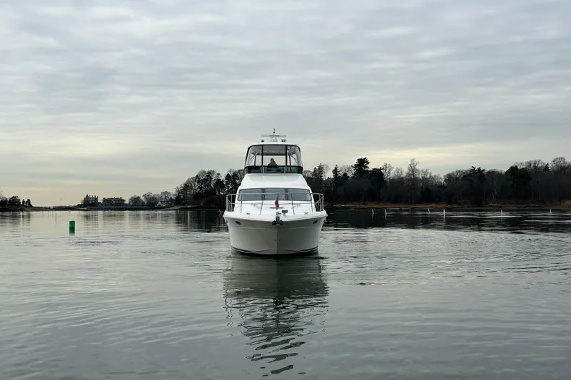  Yacht Photos Pics 2008 Sea Ray 52 Sedan Bridge yacht on calm water, overcast sky.