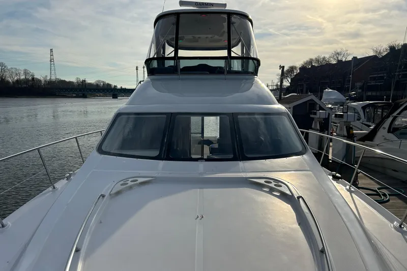  Yacht Photos Pics 2008 Sea Ray 52 Sedan Bridge yacht docked by the water on a sunny day.