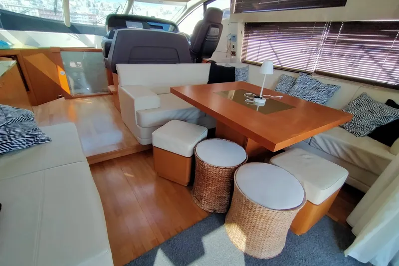  Yacht Photos Pics Luxurious interior of 2009 Sunseeker Predator 64 yacht with elegant seating and wooden table.