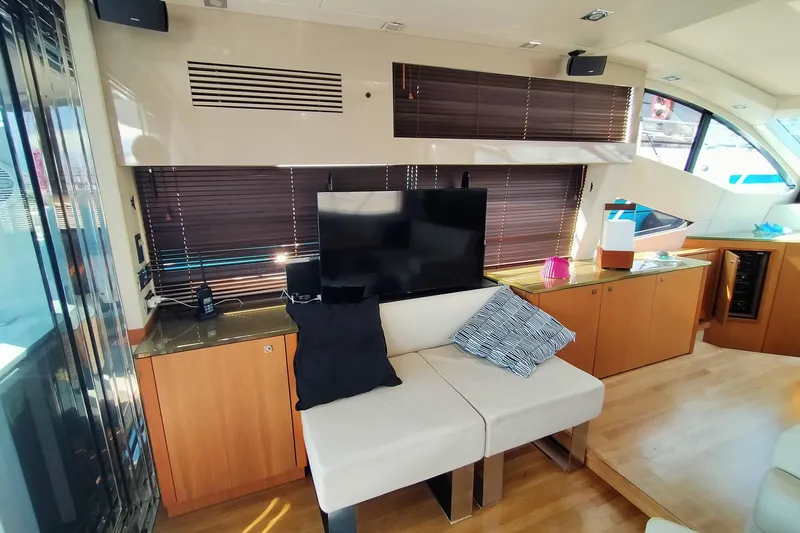  Yacht Photos Pics Luxurious interior of 2009 Sunseeker Predator 64 yacht with modern furnishings and entertainment setup.