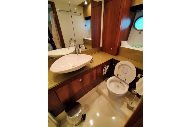  Yacht Photos Pics Luxurious bathroom in 2009 Sunseeker Predator 64 yacht with modern fixtures and wood accents.
