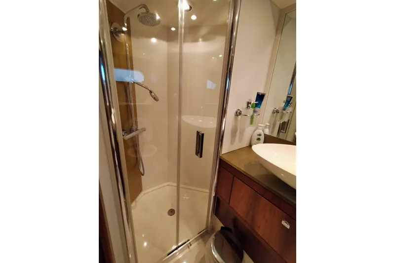  Yacht Photos Pics Luxurious bathroom in 2009 Sunseeker Predator 64 yacht with modern shower and sink.