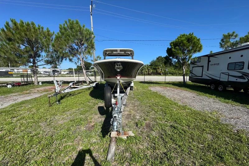  Yacht Photos Pics 2018 Chris-Craft Calypso 30 boat on trailer, parked outdoors near trees and RV.