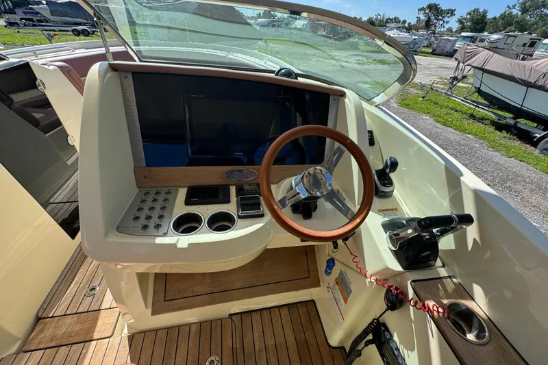  Yacht Photos Pics 2018 Chris-Craft Calypso 30 helm with wooden steering wheel and control panel.