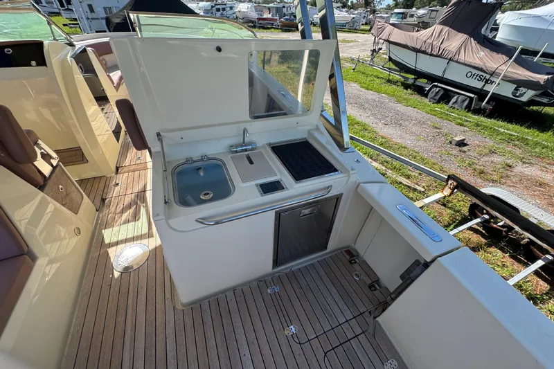  Yacht Photos Pics 2018 Chris-Craft Calypso 30 boat interior with kitchenette and sink.