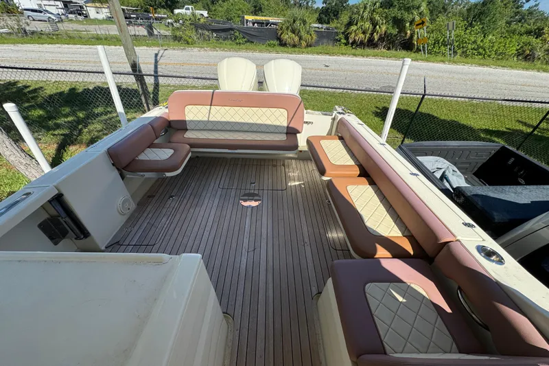  Yacht Photos Pics 2018 Chris-Craft Calypso 30 boat interior with cushioned seating and wooden deck.