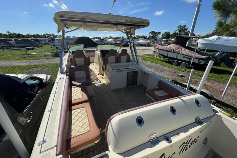  Yacht Photos Pics 2018 Chris-Craft Calypso 30 boat with spacious seating and elegant design in a marina setting.