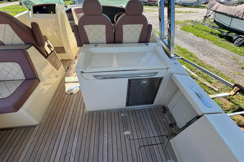  Yacht Photos Pics 2018 Chris-Craft Calypso 30 interior with luxurious seating and wooden flooring.