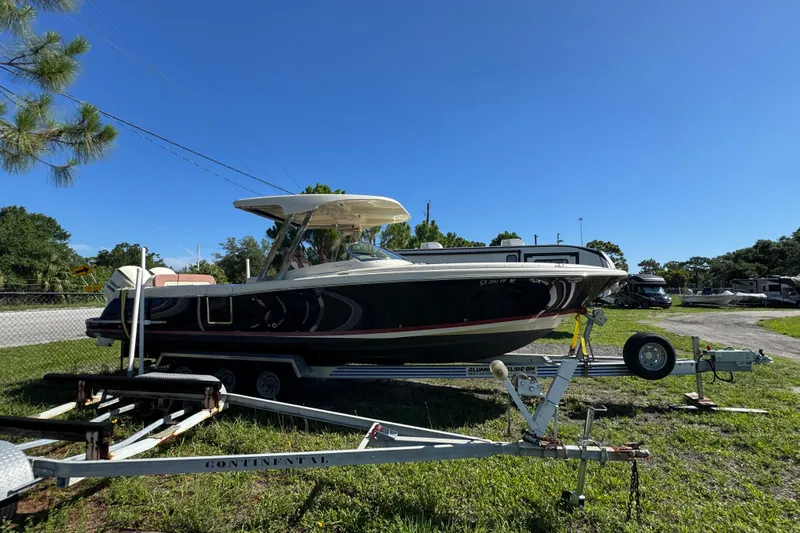  Yacht Photos Pics 2018 Chris-Craft Calypso 30 boat on trailer under clear blue sky.