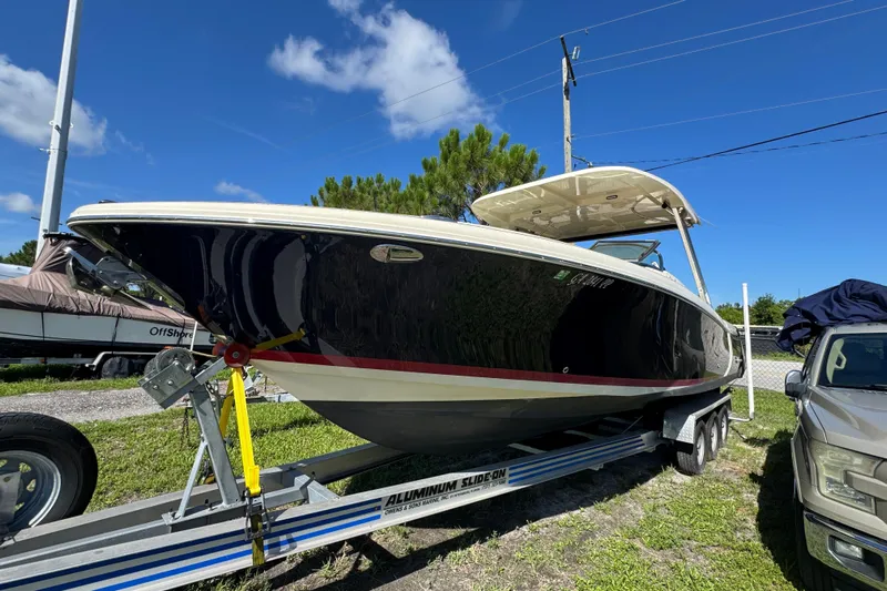  Yacht Photos Pics 2018 Chris-Craft Calypso 30 boat on trailer under clear blue sky.