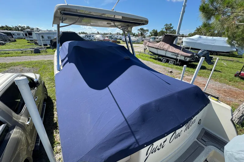  Yacht Photos Pics 2018 Chris-Craft Calypso 30 boat covered with blue tarp in storage lot.