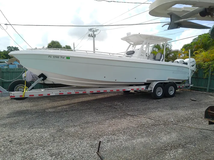  Yacht Photos Pics 2025 Glasstream 328 SCX boat on trailer, parked outdoors.