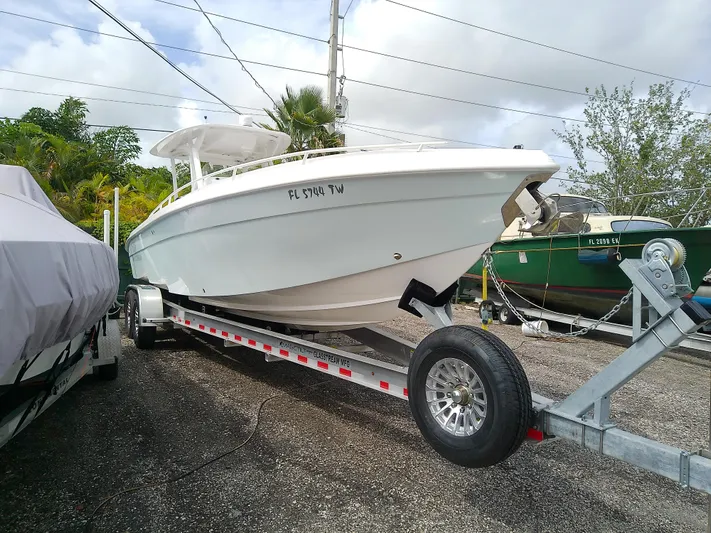 Yacht Photos Pics 2025 Glasstream 328 SCX boat on trailer, parked outdoors under cloudy sky.