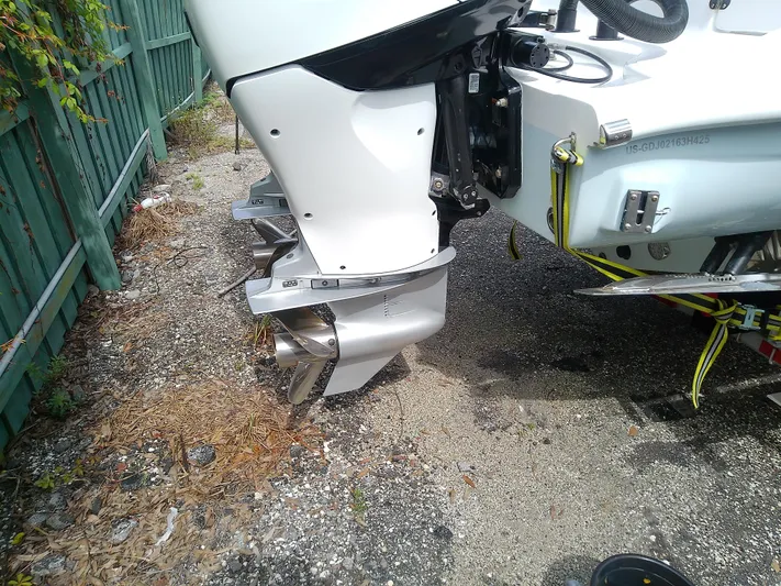  Yacht Photos Pics 2025 Glasstream 328 SCX boat engine and propeller detail, parked on gravel.
