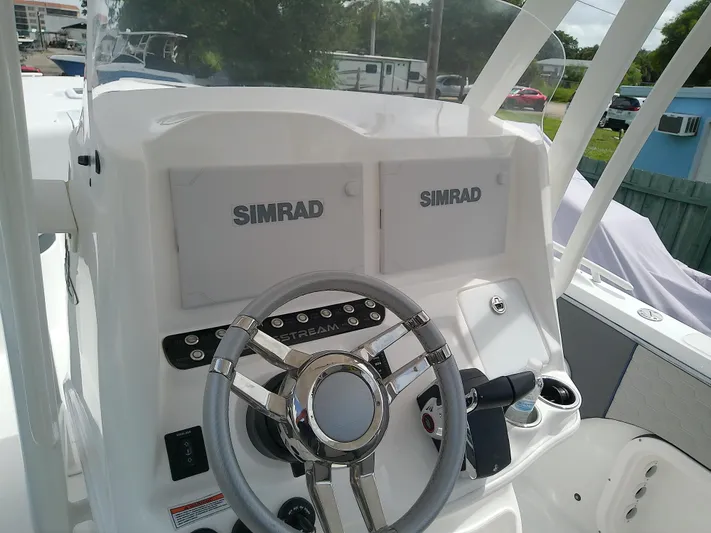  Yacht Photos Pics 2025 Glasstream 328 SCX boat dashboard with dual Simrad displays and steering wheel.
