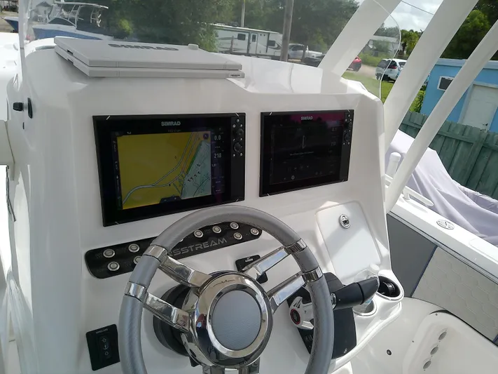 Yacht Photos Pics 2025 Glasstream 328 SCX boat dashboard with dual Simrad displays and steering wheel.