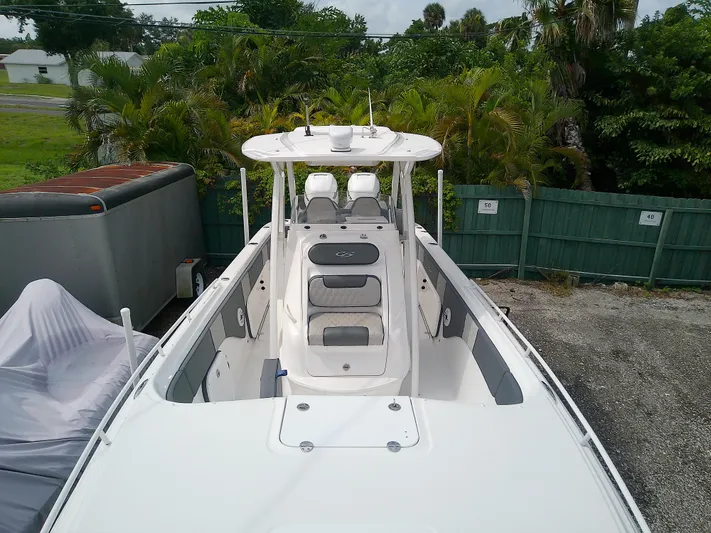  Yacht Photos Pics 2025 Glasstream 328 SCX boat, white exterior, parked outdoors near greenery.