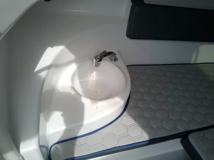  Yacht Photos Pics 2025 Glasstream 328 SCX interior with sink and cushioned flooring.