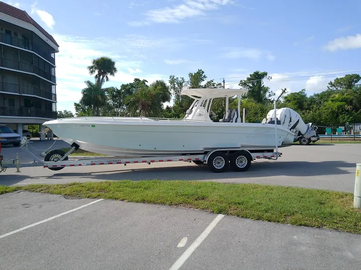  Yacht Photos Pics 2025 Glasstream 328 SCX boat on trailer in parking lot, sunny day.