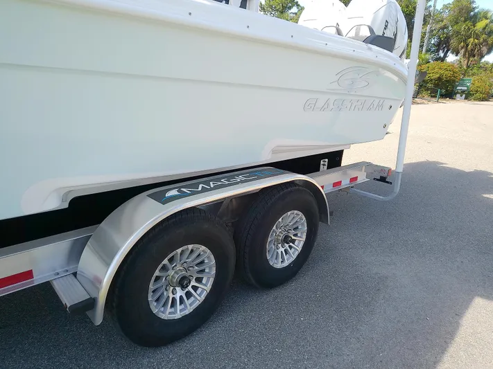  Yacht Photos Pics 2025 Glasstream 328 SCX boat on trailer, showcasing sleek design and dual wheels.