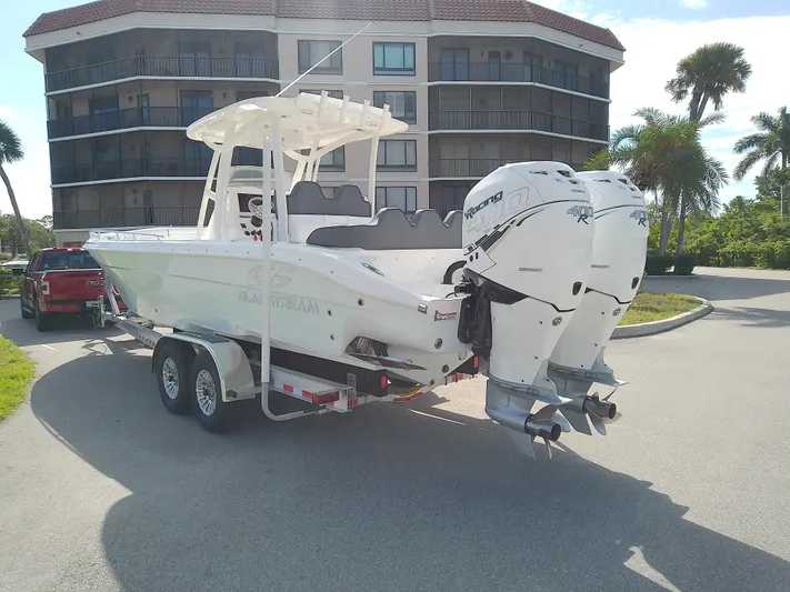  Yacht Photos Pics 2025 Glasstream 328 SCX boat on trailer with dual engines, parked near a building.