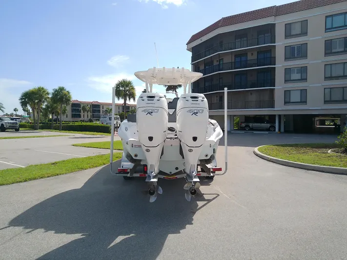  Yacht Photos Pics 2025 Glasstream 328 SCX boat with dual engines parked near residential building.