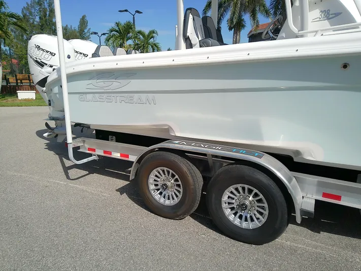  Yacht Photos Pics 2025 Glasstream 328 SCX boat on trailer, featuring dual engines and sleek design.