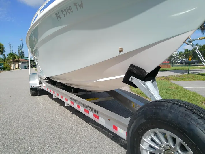 Yacht Photos Pics 2025 Glasstream 328 SCX boat on trailer, parked outdoors on a sunny day.