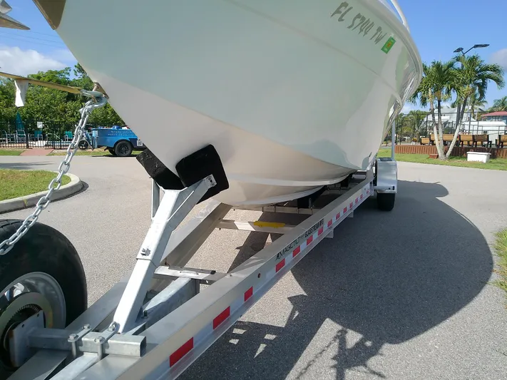  Yacht Photos Pics 2025 Glasstream 328 SCX boat on trailer, parked outdoors under clear sky.