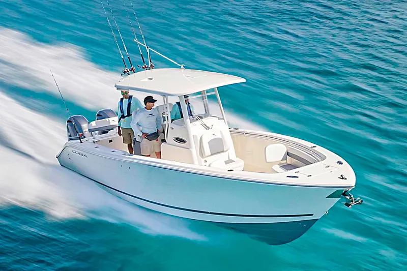  Yacht Photos Pics Manufacturer Provided Image: 2023 Cobia 280 Center Console boat cruising on clear blue water.