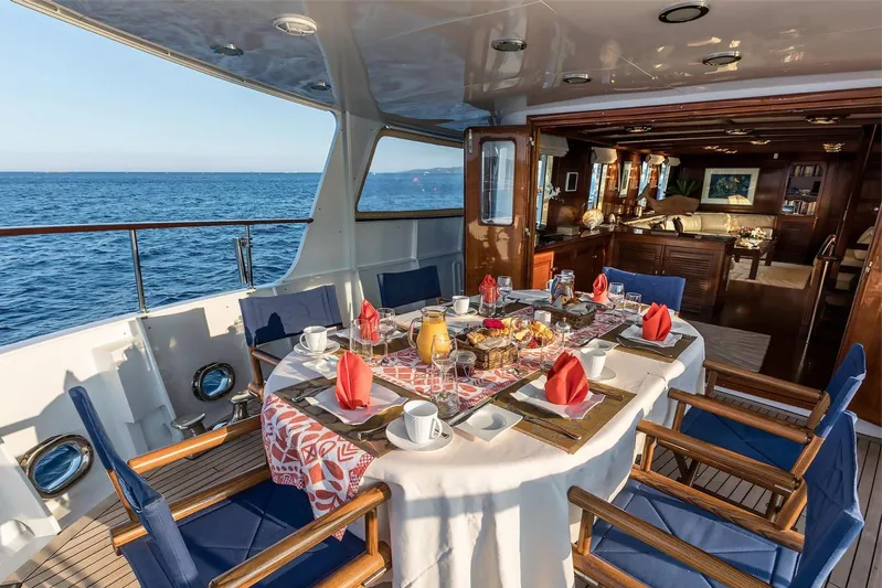 Le Kir Royal Yacht Photos Pics Luxurious dining setup on 1966 Van den Akker Le Kir Royal yacht, overlooking the ocean.