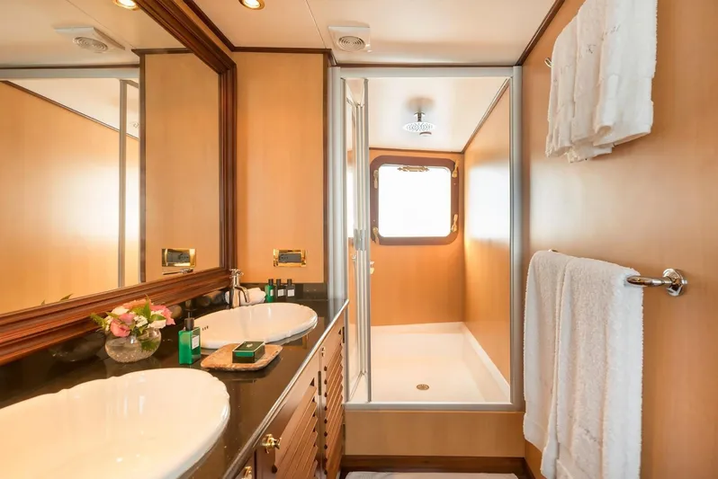 Le Kir Royal Yacht Photos Pics Luxurious yacht bathroom with double sinks, shower, and elegant wood accents, Van den Akker Le Kir Royal 1966.