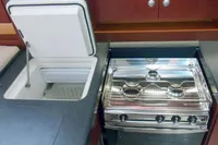 Modern kitchen in 2017 Hanse 455 yacht with stove and open fridge.