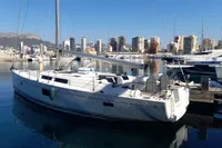 2017 Hanse 455 yacht docked in a marina with city skyline in the background.