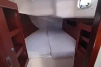 2017 Hanse 455 yacht cabin with twin beds and wooden storage shelves.