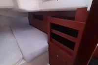 Interior cabin of 2017 Hanse 455 sailboat with bed and wooden storage.