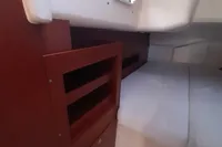 Interior cabin of 2017 Hanse 455 yacht with wooden storage and bedding.